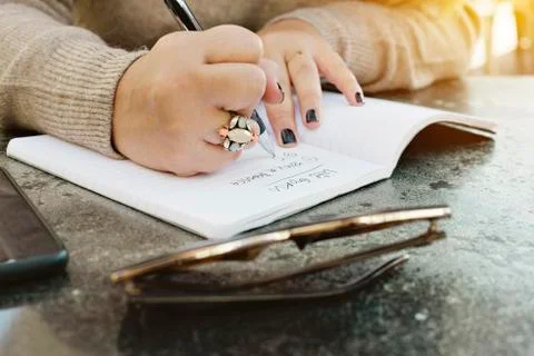 Hands of a Female Write Down Her Life Goals in a Journal Stock Photos