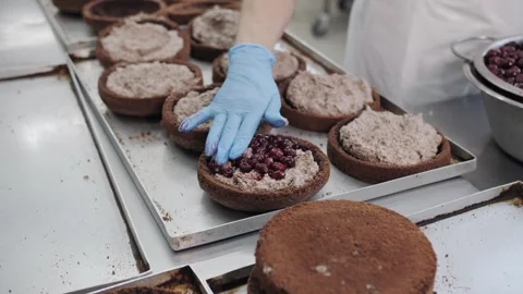 Hands Filling Cherry Cake Layers in Bakery Confectionery Production. Stock Footage 321808447