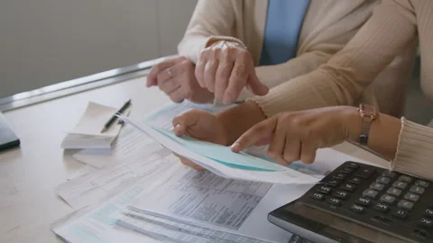 Hands of Financial Advisor and Elderly Woman Estimating Expenses Vidéo 247440654
