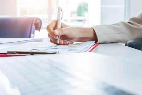 Hands of financial manager taking notes when working on report, Women working Photos