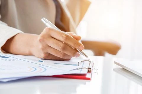 Hands of financial manager taking notes when working on report, Women working Stock Photos