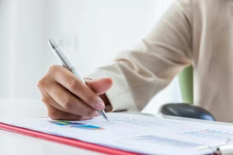 Hands of financial manager taking notes when working on report, Women working Photos