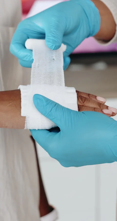 Hands, first aid and gloves with bandage at office, teaching and staff training Stock Footage 332986109