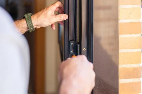 Hands fixing door frame with screwdriver doing diy home repair Stock Photos
