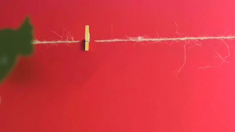 Hands fixing a paper heart with congratulation and wings with a clothespin near Stock Footage 73309517