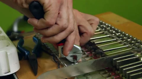 Hands fixing a piano with tools Видео 47323027