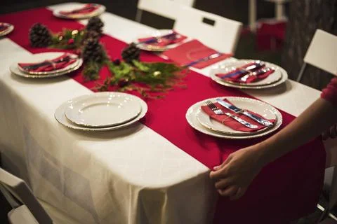 Hands fixing red table runner dinner. High quality photo Stock Photos