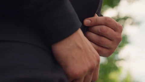 Hands fixing zipper, man preparing for nature walk, closeup of hands fixing Stock Footage 326491089