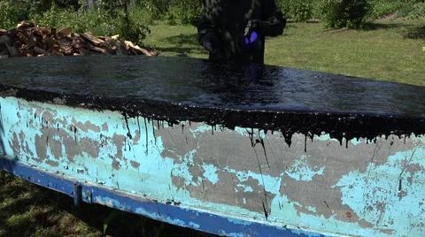 Hands with flame from torch tool patch boat bottom with hot tar. 4K Stock Footage 66712719