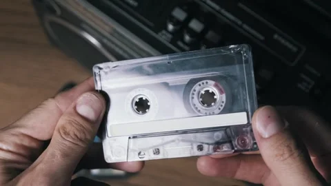 Hands Flip Transparent Cassette Tape Over Video stock 319039191