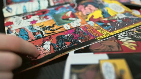 Hands flipping comic book pages. Comics background 4K Stock Footage 133650115