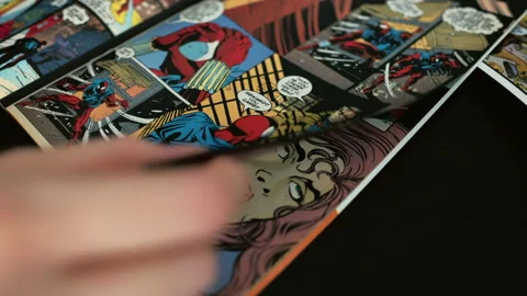 Hands flipping comic book pages. Comics background 4K Stockbeeldmateriaal 133650383