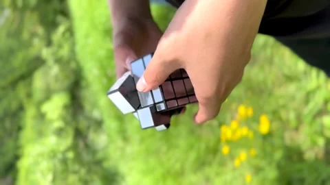 Hands fold a rubik's cube from different shapes Stock Footage 242792549
