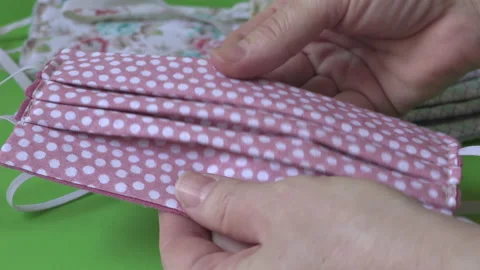 Hands folding colorful DIY face masks during COVID-19 pandemic Stock Footage 132362955