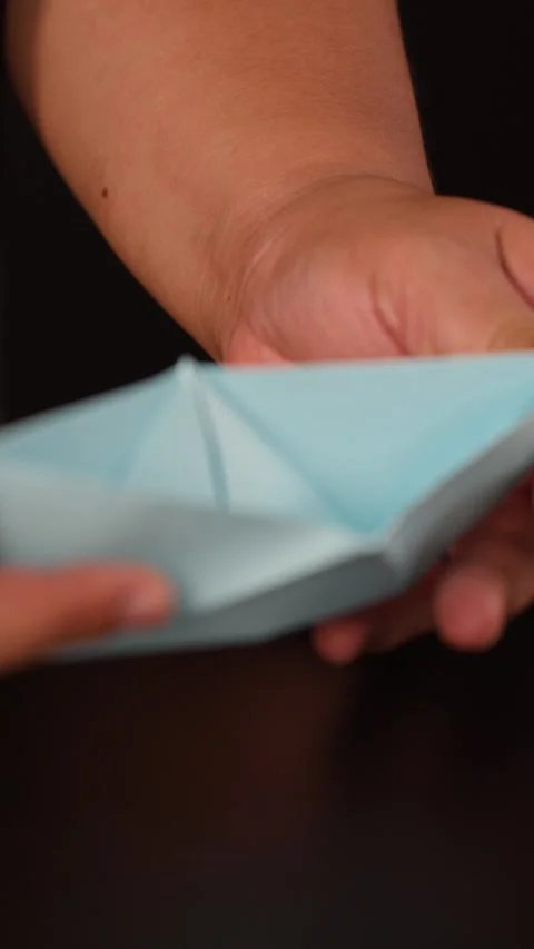 Hands Folding Light Blue Origami Paper on Table Stock Footage 326030102