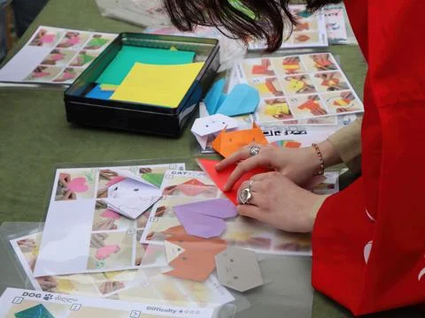 Hands Folding Origami Figures at a Workshop. Stock Photos