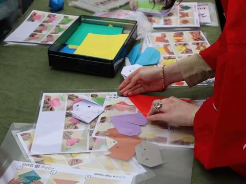 Hands Folding Origami Figures at a Workshop. 写真素材