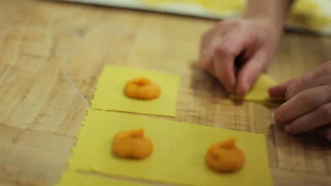 Hands folding Pasta Ripiena in kitchen Stock Footage 107570040
