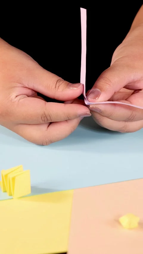 Hands Folding Pink Paper Strip for Origami Craft Vídeos de archivo 318720358