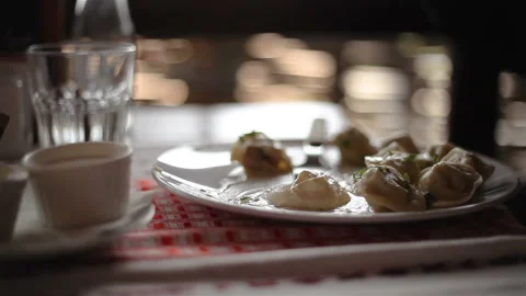 Hands with a fork eating Russian dumplings and chops, accelerated close-up shoot Stock Footage 150274605