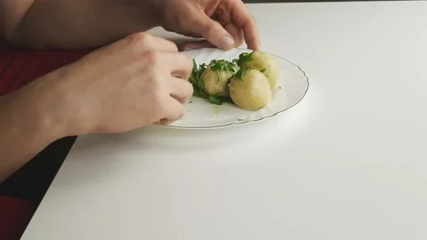 Hands with fork in hand take khinkali from the plate.On a white table. Stock Footage 131076737