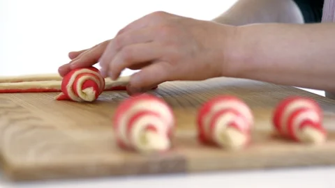 Hands form a croissant of two-color dough. Stock Footage 89387776
