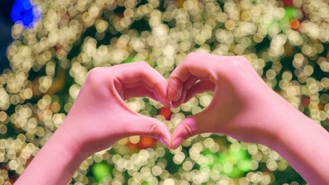 Hands in the form of heart against the light blurred background in Christmas Stock-Footage 154013749