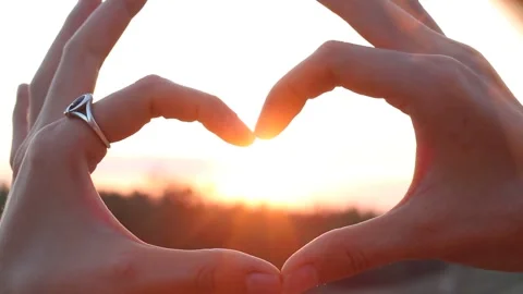 Hands Forming Heart Shape Against Sunset Stock Footage 346027642