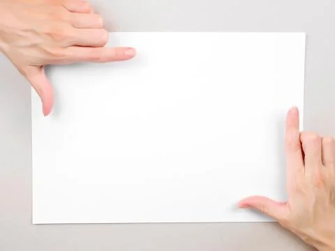 Hands frame over paper sheet. Stock-Fotos