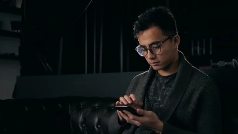 Hands free calling with smart phone. Asian man korean voice recognition ai Stock Footage 100508467