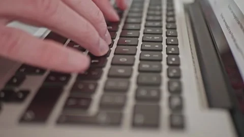 Hands of freelancer typing on silver notebook keyboard, close up view. 库存影片 334116679