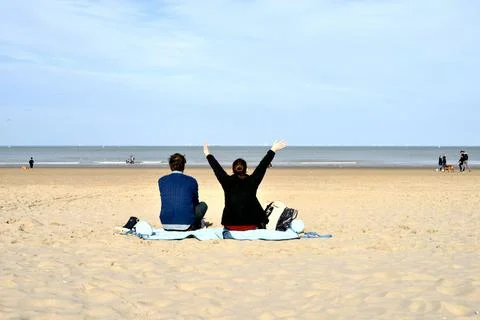 Hands up in front of the sea 写真素材