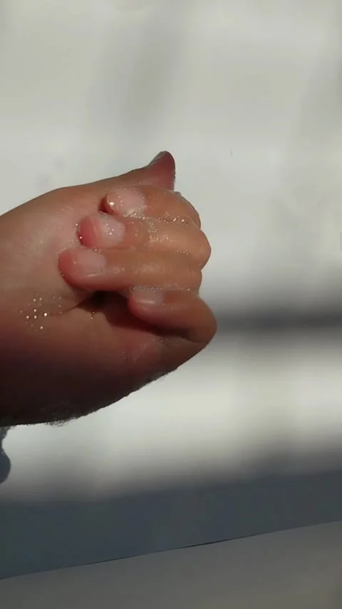 Hands full of bubbles, under the sunlight. White background. Stock Footage 329787340