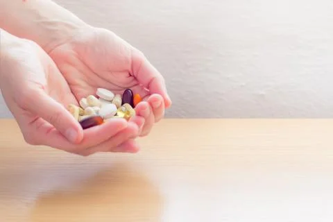 Hands full of pills Stock Photos