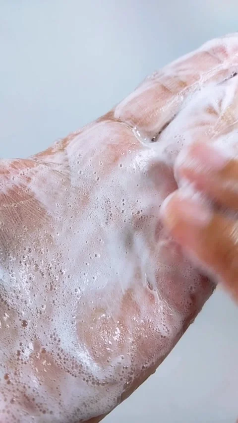 Hands full of white soap foam. Process of washing palms and spreading foam .. Stock Footage 346746048