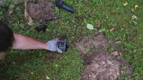 Hands of gardener setting a mole trap Stock Footage 256235863