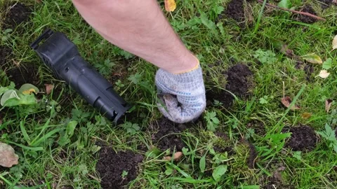 Hands of gardener setting a mole trap Stock Footage 266123785