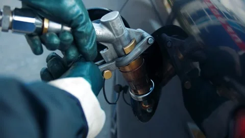 Hands of a gas station worker as he attaches a nozzle to propane filler valve 動画素材 312964207