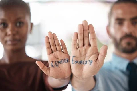 Hands, gender equality and unity with a sign message on the hand of a business Stock Photos