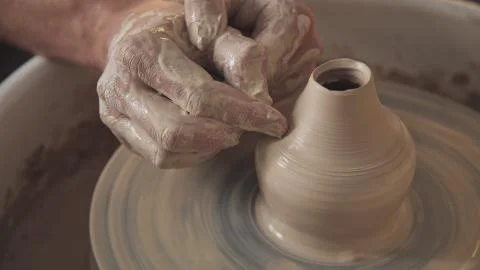 Hands gently create correctly shaped handmade from clay. Stock Photos
