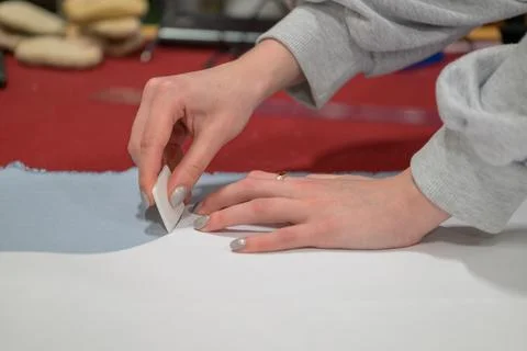 Hands gently fold fabric with precision and care Stock Photos