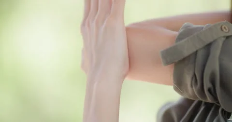 Hands gently interlocking during a serene outdoor moment, showcasing warmth and Stock Footage 318274125