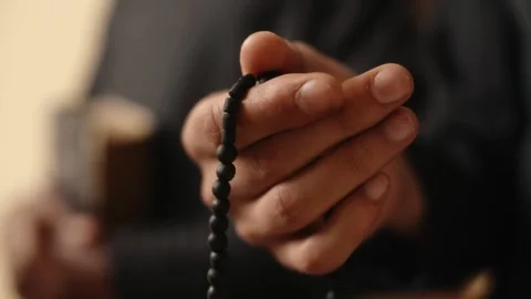 Hands Gently Moving Black Prayer Beads in Meditation Stock Footage 338217080
