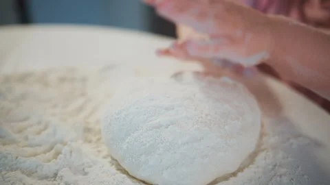 Hands gently shaping dough in flour Stock-Footage 336047928