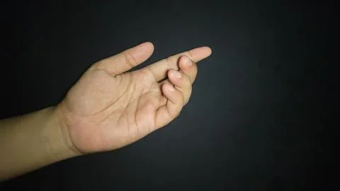 Hands with a gesture asking for help. Isolated on black background 写真素材