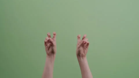 Hands Gesturing Air Quotes in Front of Green Backdrop Stock Footage 208788546