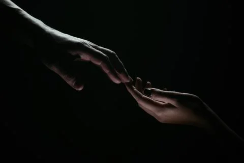 Hands gesturing on black background. Giving a helping hand. Support and help Stock Photos