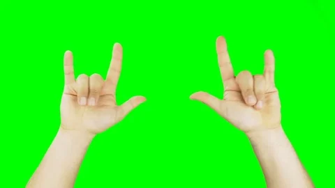 Hands gesturing heavy metal rock sign isolated green screen Stock Footage 76511588