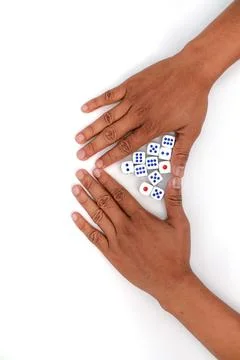 Hands Gesturing Towards Dice On A White Background With Blue Dots Stock Photos