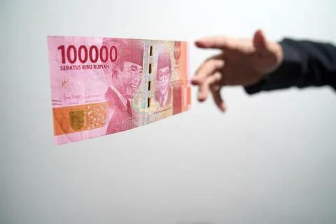 Hands getting ready to catch a hundred thousand rupiah bill on a white backgr Stock Illustration